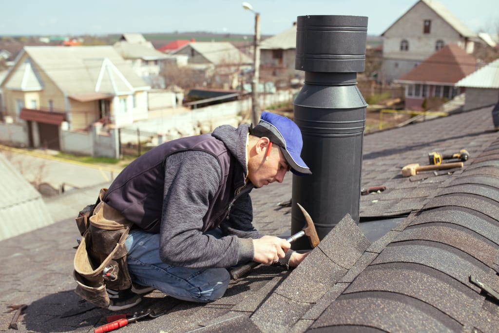 Roofing Technician Repairing Roof