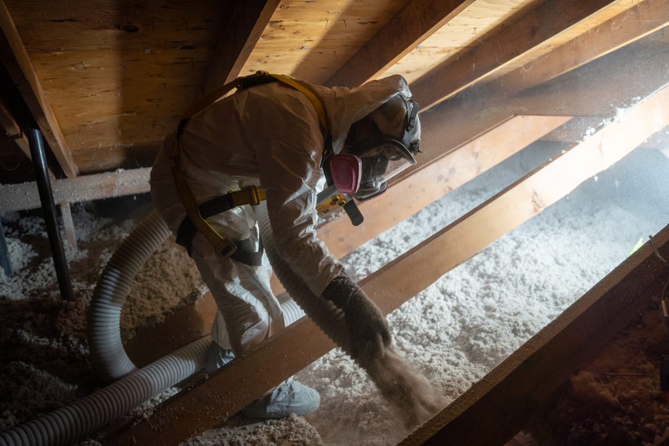 Guardian technician installing blown-in cellulose Insulation